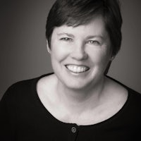 a black and white photo of a woman smiling